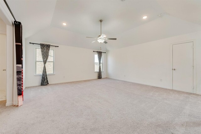 spare room with light carpet, ceiling fan, vaulted ceiling, and recessed lighting