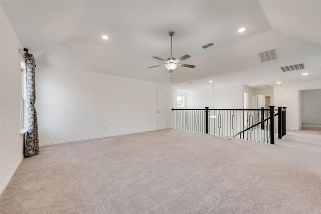 empty room featuring visible vents, vaulted ceiling, and recessed lighting