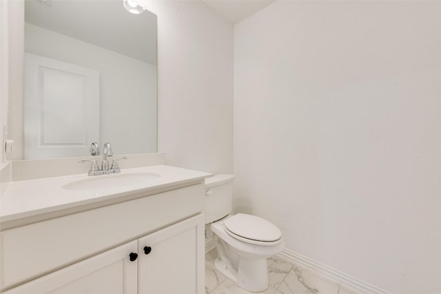 half bath with marble finish floor, toilet, vanity, and baseboards