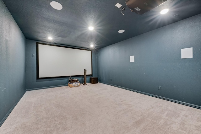 cinema with a textured ceiling, carpet floors, a textured wall, and recessed lighting