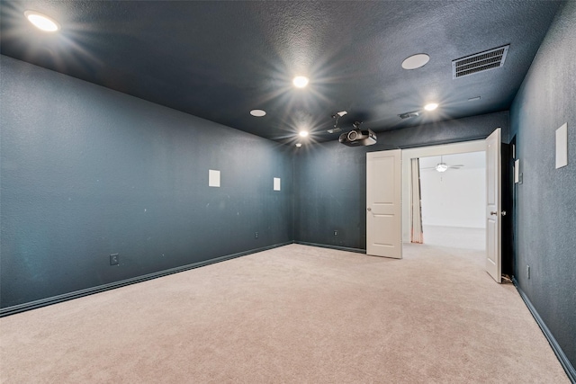 empty room with recessed lighting, light colored carpet, visible vents, a textured wall, and a textured ceiling