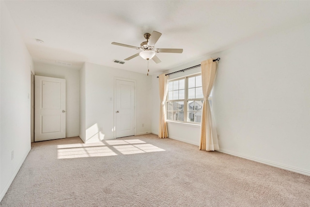 unfurnished bedroom with baseboards, visible vents, and light colored carpet