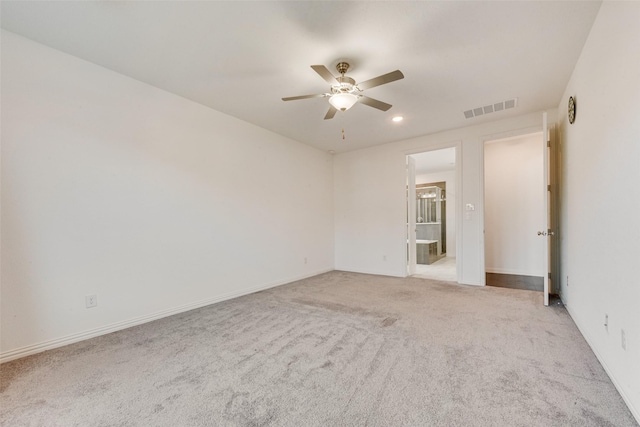 empty room featuring a ceiling fan, recessed lighting, visible vents, and light carpet