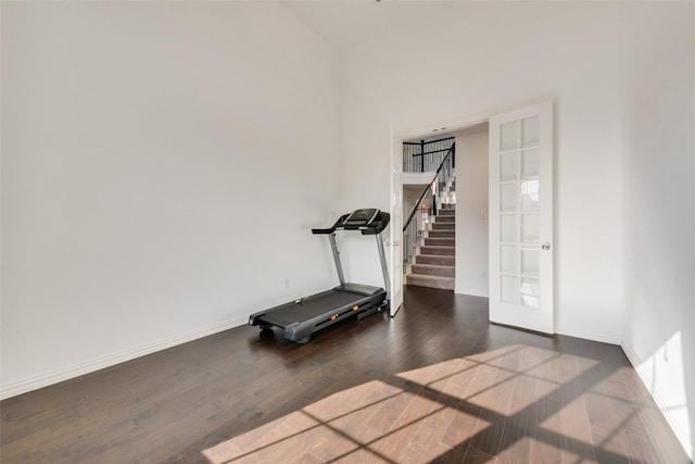 exercise area featuring dark wood-style floors and baseboards