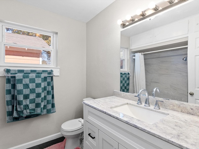 bathroom with vanity, toilet, and curtained shower