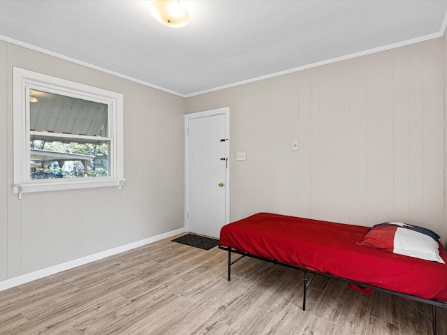 bedroom featuring light hardwood / wood-style floors and ornamental molding