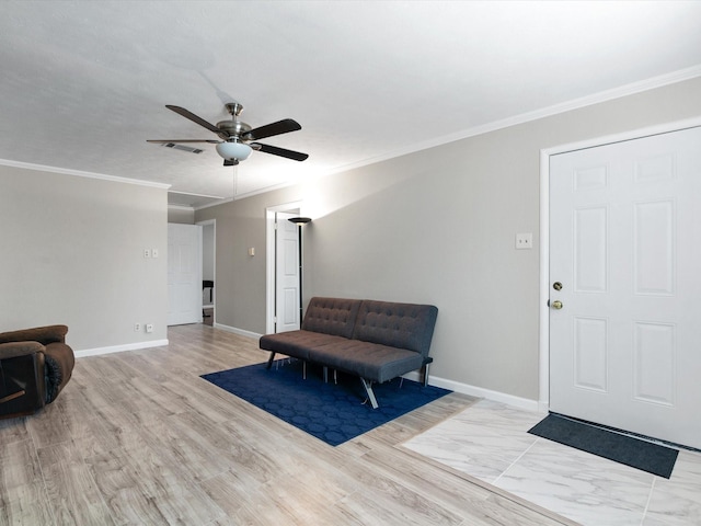 sitting room featuring crown molding and light hardwood / wood-style floors