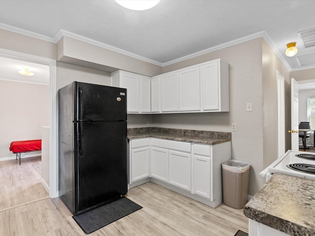 kitchen featuring white cabinetry, black fridge, light hardwood / wood-style flooring, and crown molding