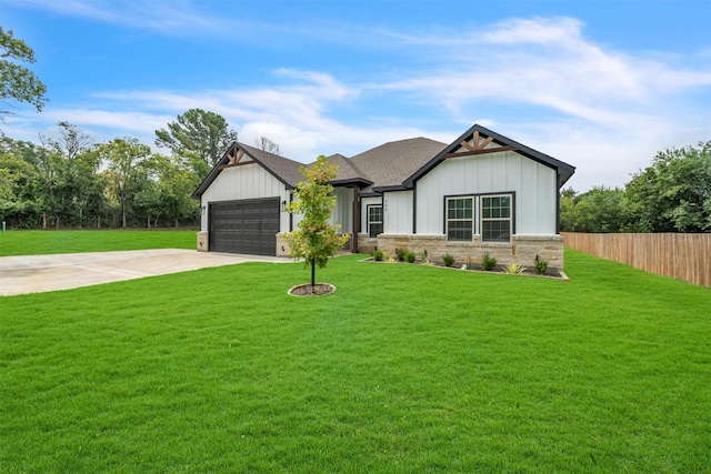 view of front of house featuring a garage and a front lawn