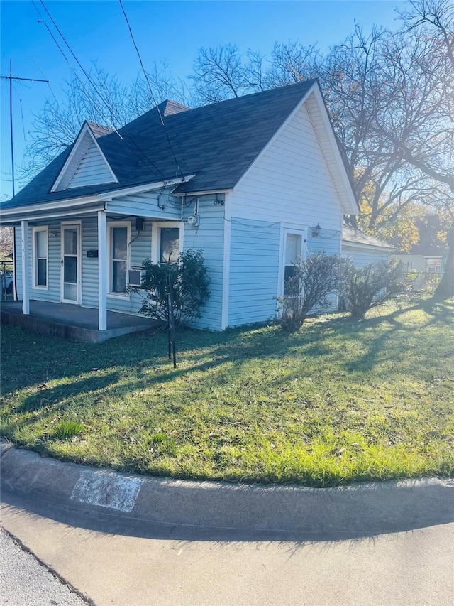 view of home's exterior featuring a yard and a porch