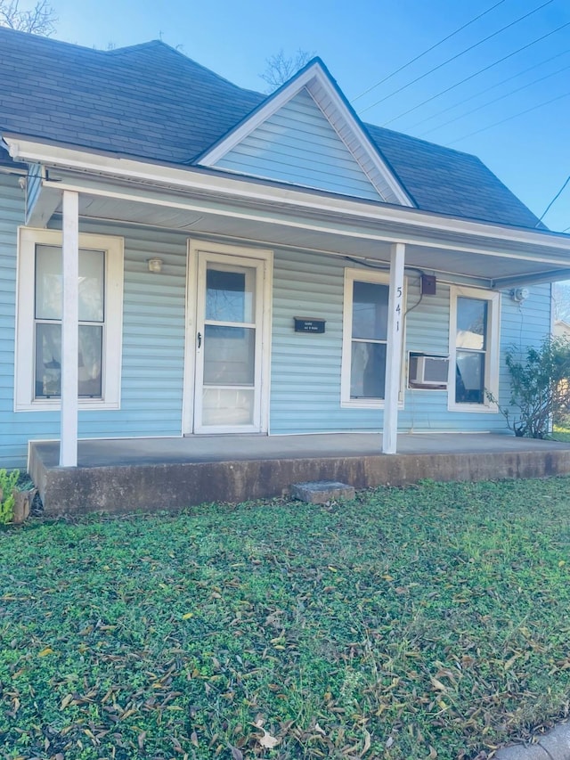 view of front facade featuring covered porch and cooling unit