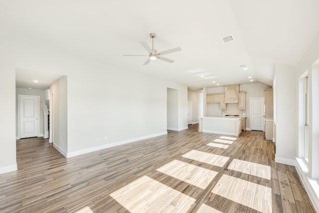 unfurnished living room with ceiling fan, light hardwood / wood-style flooring, and lofted ceiling