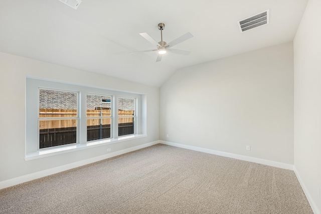 spare room featuring ceiling fan, lofted ceiling, and carpet floors