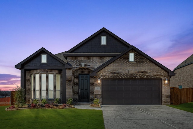 view of front facade with a yard and a garage