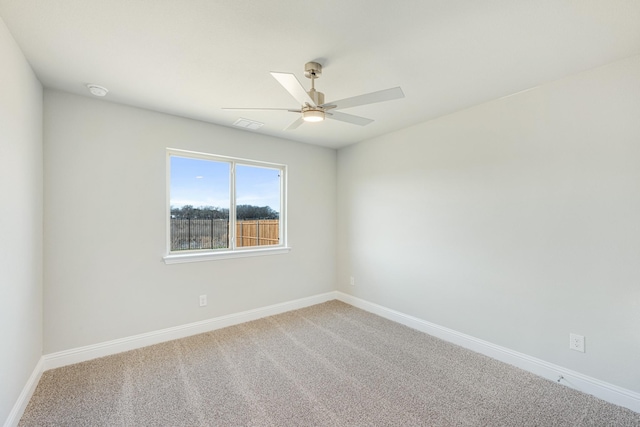 carpeted empty room featuring ceiling fan