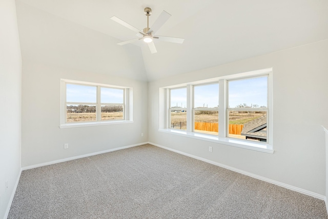 empty room with vaulted ceiling, plenty of natural light, and carpet flooring