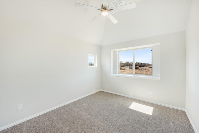 empty room with vaulted ceiling, ceiling fan, and carpet