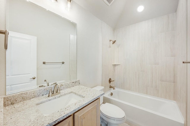 full bathroom featuring toilet, vaulted ceiling, vanity, and bathing tub / shower combination