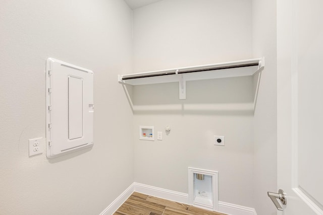 laundry area with hookup for a washing machine, hookup for a gas dryer, electric panel, electric dryer hookup, and hardwood / wood-style flooring