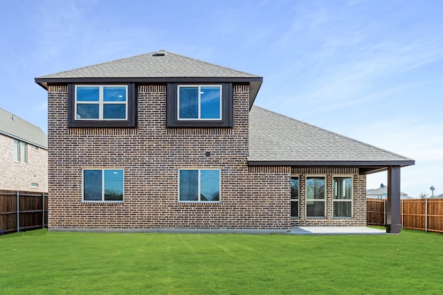 back of property with a patio and a lawn