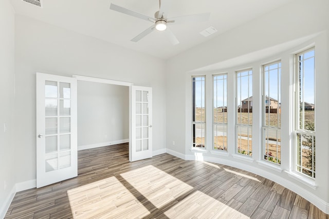 spare room with ceiling fan, french doors, and plenty of natural light