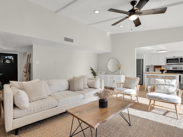 living room featuring beamed ceiling, ceiling fan, and high vaulted ceiling