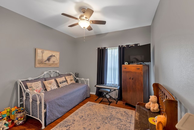 bedroom with wood-type flooring and ceiling fan