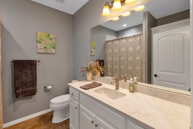 bathroom featuring vanity, curtained shower, and toilet