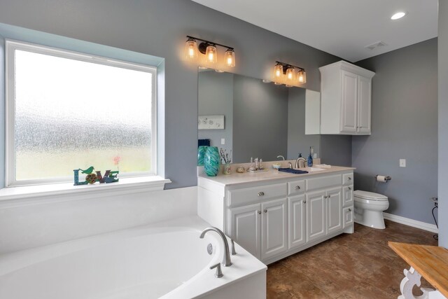 bathroom with a bath, vanity, and toilet