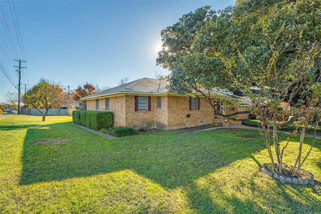 view of side of home featuring a yard