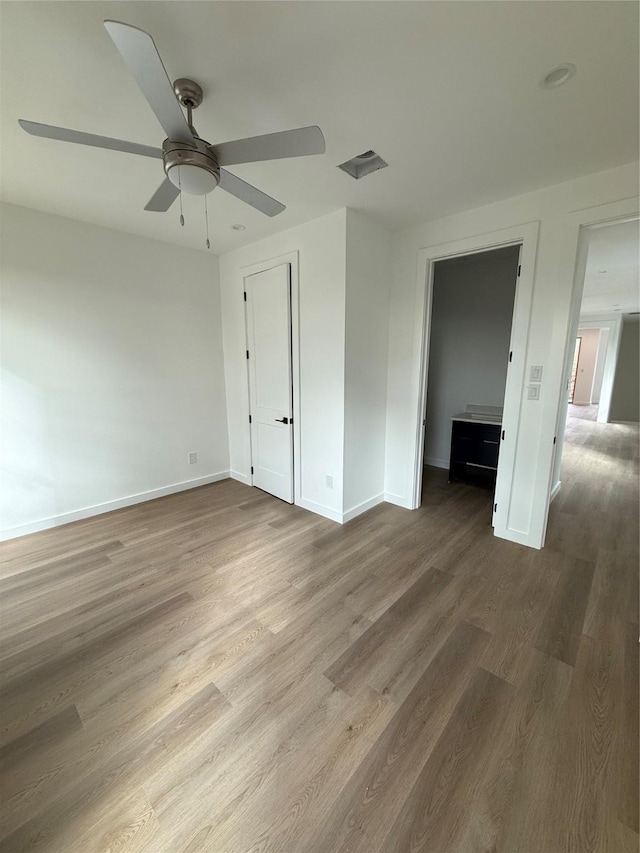 unfurnished bedroom featuring ceiling fan and wood-type flooring