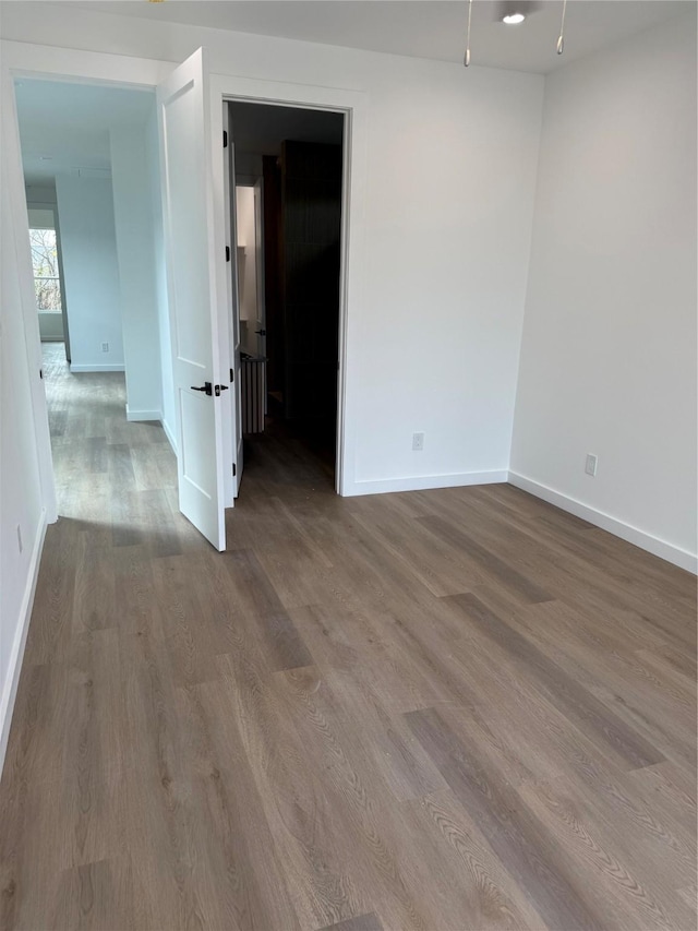 empty room with hardwood / wood-style flooring