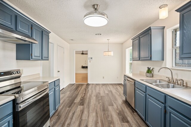 unfurnished dining area featuring ceiling fan, wood-type flooring, and a textured ceiling