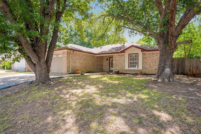 view of front of home with central AC unit and a garage