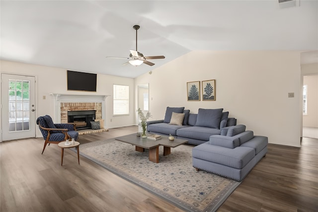 unfurnished living room featuring dark hardwood / wood-style floors, ceiling fan, lofted ceiling, and a fireplace