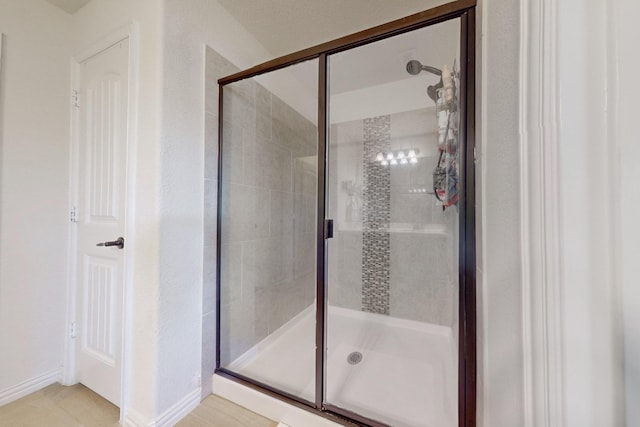 bathroom with a shower with door