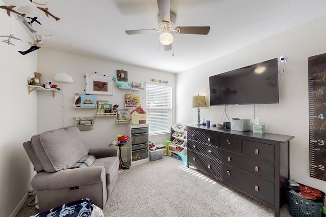 sitting room featuring ceiling fan and carpet floors