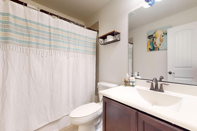 full bathroom with vanity, toilet, and shower / tub combo