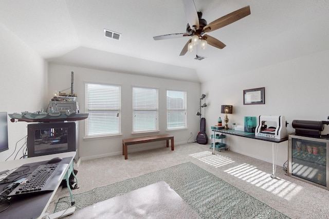 carpeted office space with vaulted ceiling and ceiling fan