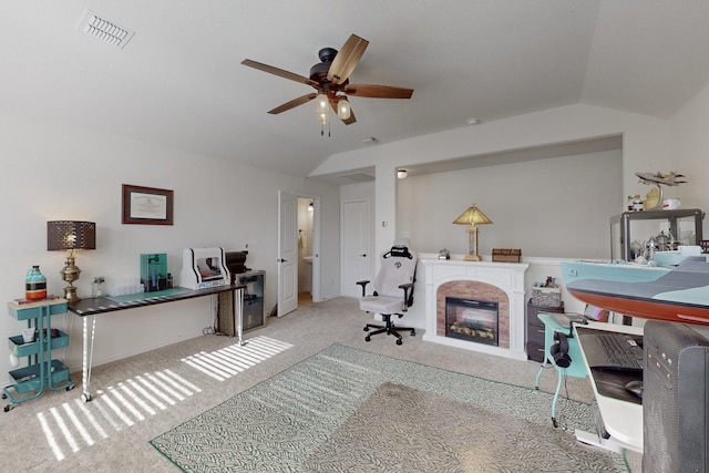 home office featuring lofted ceiling, carpet floors, and ceiling fan