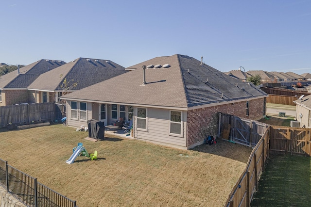 back of house featuring a patio and a yard