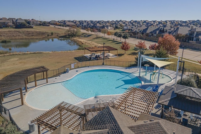 view of pool featuring a pergola, a water view, a yard, and a patio area