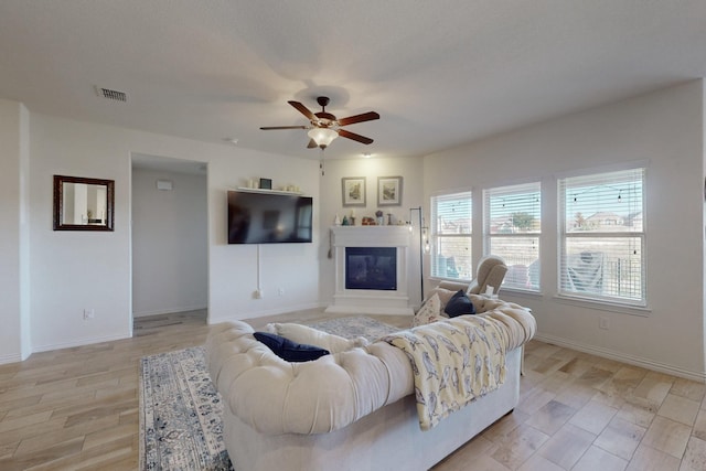 living room with ceiling fan and light hardwood / wood-style flooring