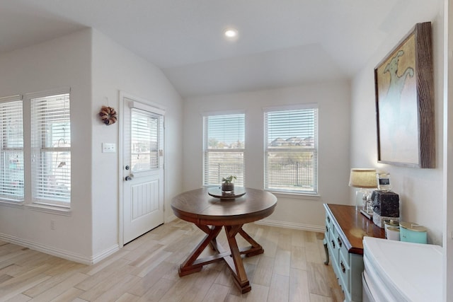 doorway to outside featuring light hardwood / wood-style flooring and vaulted ceiling