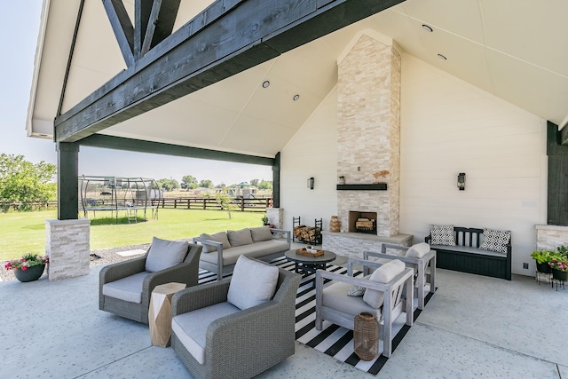 view of patio / terrace featuring an outdoor living space with a fireplace and a trampoline