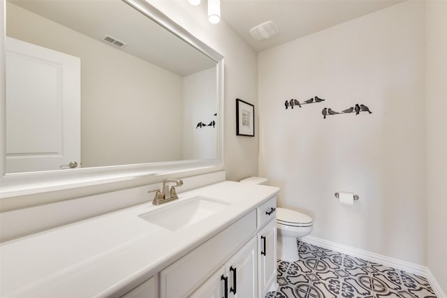 bathroom featuring tile patterned floors, vanity, and toilet