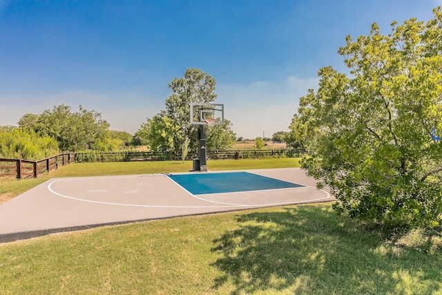 view of sport court featuring a yard