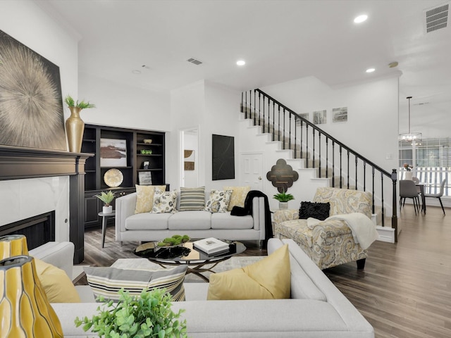 living room with an inviting chandelier and hardwood / wood-style floors