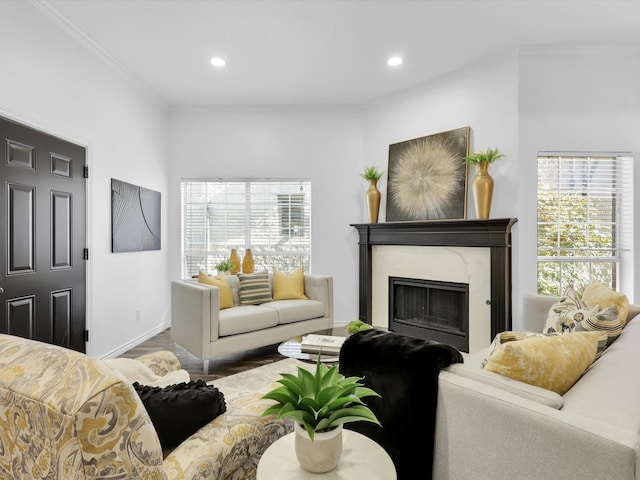 living room featuring crown molding, a high end fireplace, and hardwood / wood-style flooring