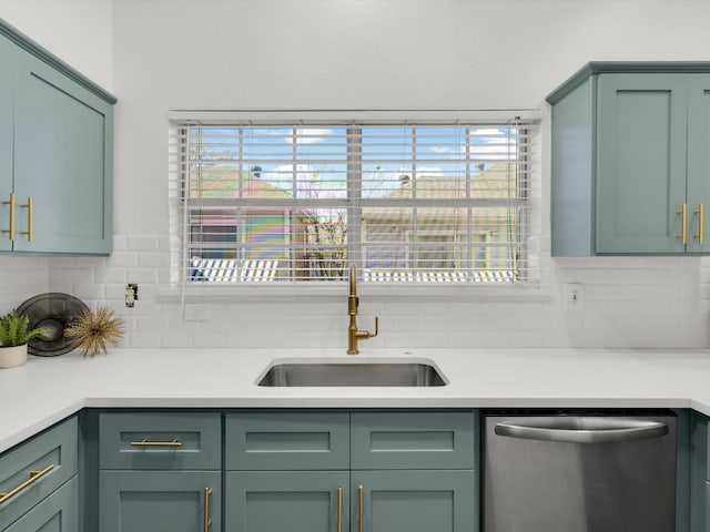 kitchen featuring dishwasher, sink, backsplash, and green cabinetry